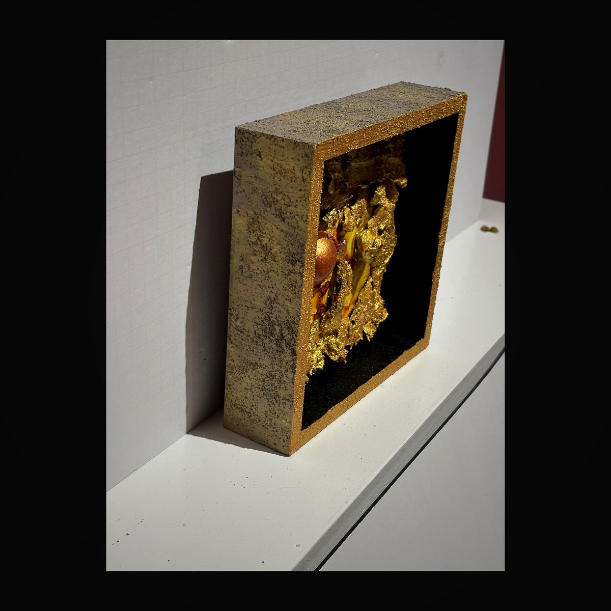 Warm amber tones with textured gold leaf in a dimensional vessel form