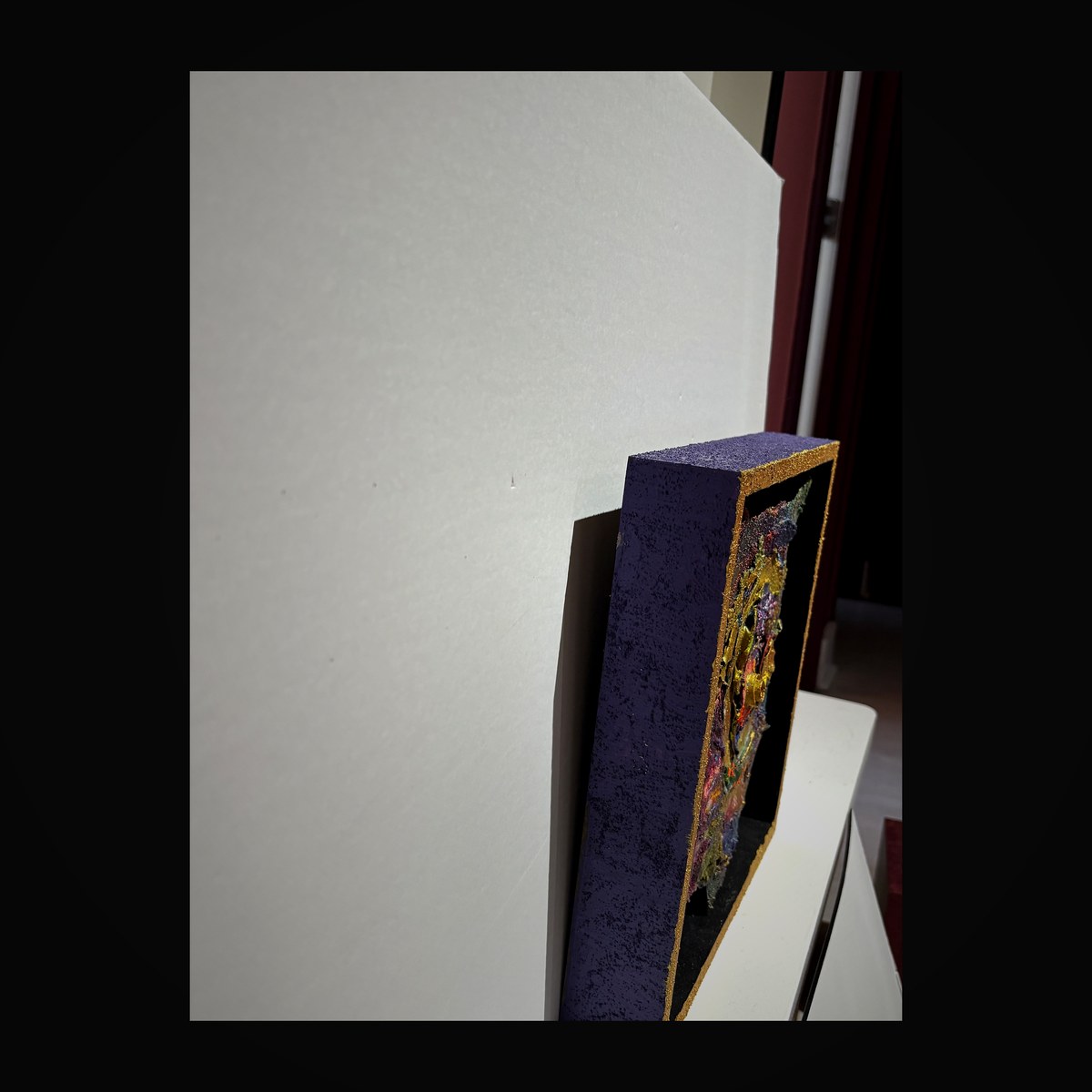 Deep violet enamel vessel with gold trim and colorful cloisonné interior